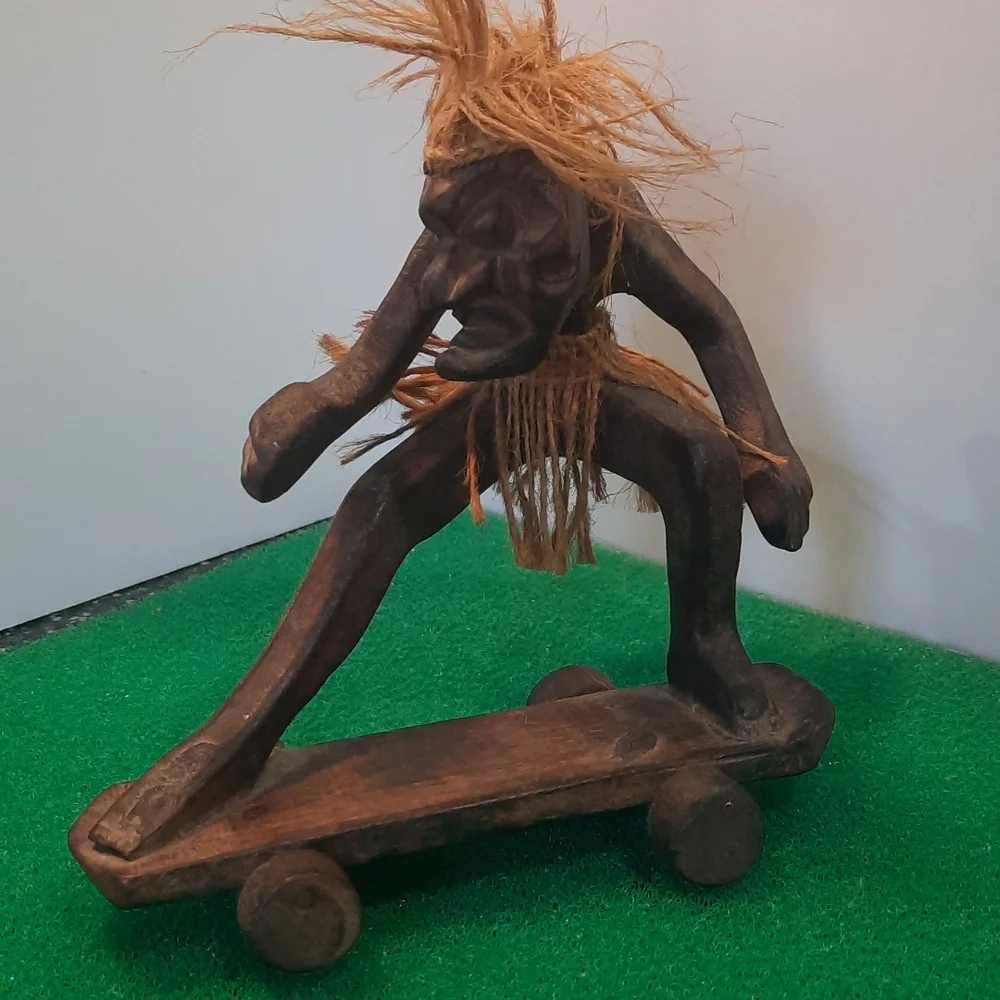 Hand carved wooden Hawaiian Tiki skateboard dude
